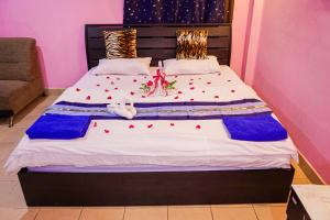 a bed with red hearts on it in a room at Marine paradise Encore in Pattaya South