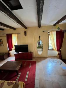 a living room with red curtains and a red rug at Grotta dell'edera in Finale Ligure