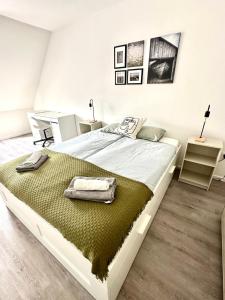a bedroom with a large bed with a green blanket at Palace Quarter 2 Peaceful Modern Central Top Floor Apartment in Budapest