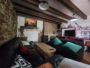 a living room with a couch and a table at Casa Jerónimo in Loporzano