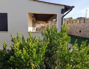 a white house with trees in front of it at Villa Azzurra in Lampedusa