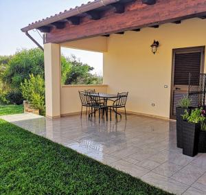 a patio with a table and chairs on it at Villa Azzurra in Lampedusa