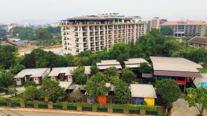 an overhead view of a building with trees and houses at Hailin Resort Vangvieng in Vang Vieng