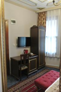 a hotel room with a desk and a mirror at Emirhan Inn Hotel & Suites in Istanbul