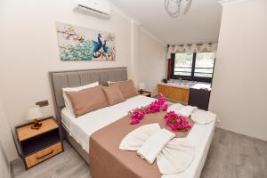 a bedroom with a bed with flowers on it at Mykonut Boutique Suites in Fethiye