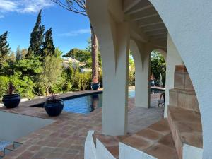an archway leading to a swimming pool in a house at Maison d'Orange - La Pinede in Saint-Tropez