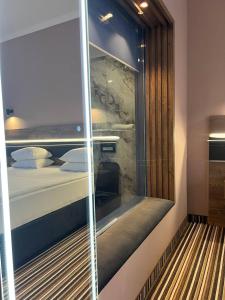 a room with a window with a bed in it at Sapar Standart Улучшенный полулюкс in Shymkent