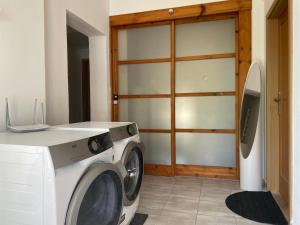 a washing machine in a room with a door at Linnets Studios in Bratislava