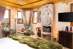 A television and/or entertainment centre at Cappadocia Pegasos Cave Suite Hotel