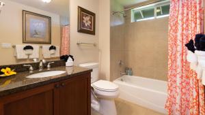 a bathroom with a sink and a toilet and a tub at BY THE SEA VILLA Cheerful 3BR Halii Kai Home with Golf and Ocean Views in Waikoloa +42 photos