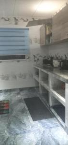 a kitchen with a table and a counter top at Dan Kazou Self Catering in La Digue +16 photos