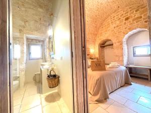 Posteľ alebo postele v izbe v ubytovaní Trulli Lamascrasciola