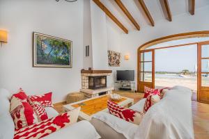 a living room with two couches and a fireplace at Finca Puig Blanc by Sealand Villas in Muro