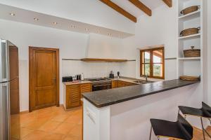 a kitchen with a counter top and a refrigerator at Finca Puig Blanc by Sealand Villas in Muro