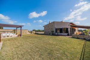 a house with a large yard in front of it at Finca Puig Blanc by Sealand Villas in Muro