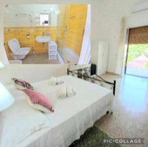 a bedroom with a white bed and a bathroom at Cialoma Full Green in Marina di Camerota