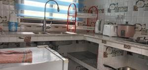 a kitchen with a sink and a counter top at Dan Kazou Self Catering in La Digue