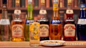 a drink and a bowl of food and bottles of alcohol at Henn na Hotel Tokyo Ginza in Tokyo