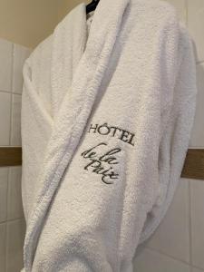 a towel hanging on a towel rack in a bathroom at The Originals Boutique, Hôtel de la Paix, Beaune (Qualys-Hotel) in Beaune