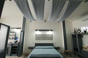 a bedroom with a bed with curtains over it at Domo Anna in Villasimius