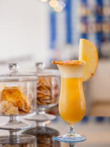 a drink with an orange slice in a glass at Grupotel Maritimo in Port d'Alcudia