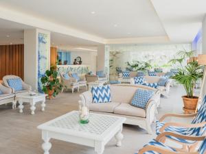 a waiting room with couches and tables at Grupotel Maritimo in Port d'Alcudia