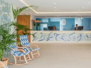 a lobby with a blue and white counter and chairs at Grupotel Maritimo in Port d'Alcudia +37 photos