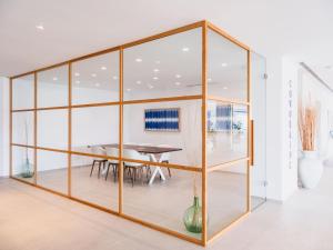 a dining room with glass walls and a table at Grupotel Maritimo in Port d'Alcudia
