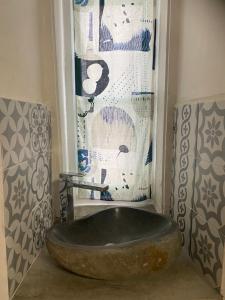 a bathroom with a large stone tub in a room at Allen easyLoft in Trieste
