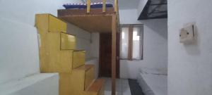 a bathroom with a yellow staircase in a room at SPOT ON 93964 Guest House Pak Gatot 3 in Bandung