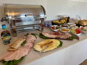 a buffet with different types of sandwiches and other foods at Pensjonat Diament in Borne Sulinowo