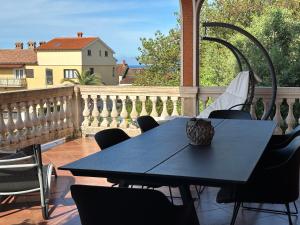 a blue table and chairs on a balcony at Apartment Peloža 1 in Poreč