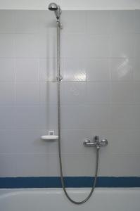 a shower with a hose in a bathroom at View of the Castle and the Sea 1 in Platamonas