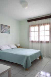 a bedroom with a bed and a window at View of the Castle and the Sea 1 in Platamonas