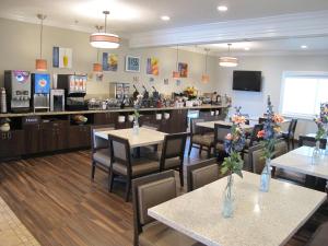 a restaurant with tables and chairs and a counter at Best Western Timpanogos Inn in Lehi