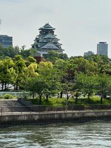 a pagoda in a city next to a river at noah grande in Osaka