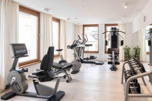 a gym with several treadmills and exercise bikes at SPA Hotel Erzherzog Johann in Bad Aussee