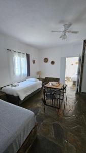 a bedroom with two beds and a table in it at Enalia Apartments in Korissia
