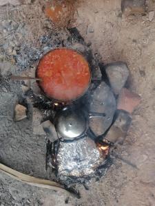 a pot is sitting on top of a fire at Dana WhiteDometrail Lodge in Dana