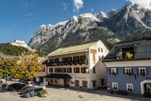 a large building with a mountain in the background at Central-Inn Werfen in Werfen