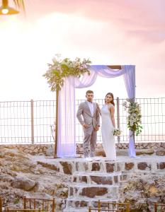 a bride and groom standing in front of a altar at GILI VIEW By Kalma in Teluknarat