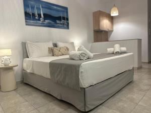 een slaapkamer met een groot bed en handdoeken bij Dedes Apartments in Skala