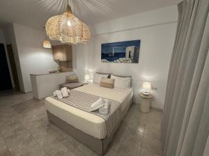 a bedroom with a bed and a chandelier at Dedes Apartments in Skala