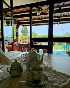 a table with a tea pot and cups on a table at A Casa del Farmacista in Casarano