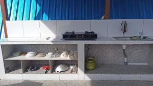a toy kitchen with a stove and a sink at Puri Pilihani Hostel in Munduk
