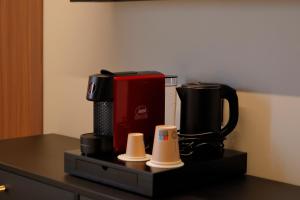 a coffee maker on a counter in a room at Hotel Namia by Dori in Bardolino