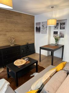 a living room with a couch and a table at JÁNOŠÍK Apartmány in Terchová