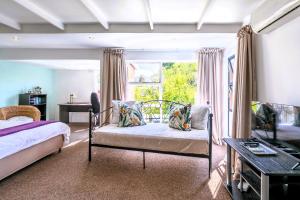a bedroom with two beds and a window at Absolute Bosch Guest House in Stellenbosch