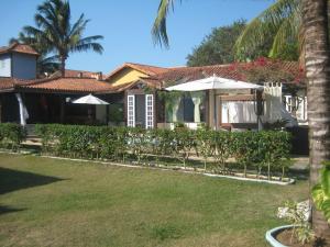 a house with a lawn in front of it at Guest House Green Garden in Búzios