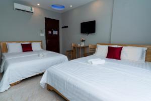 Postel nebo postele na pokoji v ubytování Hotel Eros - Phan Huy Ích